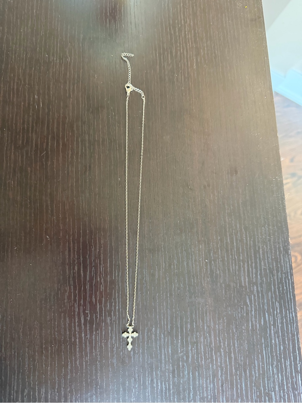 Silver-tone chain necklace with a small, rhinestone-paved cross